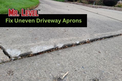 Close-up of an uneven driveway apron with a visible height difference between two concrete slabs; text overlay says “Mr. Level Fix Uneven Driveway Aprons.”.